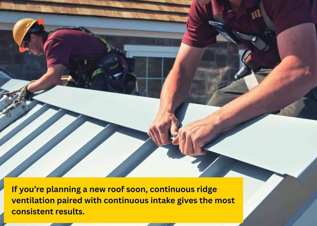 Roofing contractors securing a standing seam metal roof panel as part of fall roof vent maintenance. Caption: If you’re planning a new roof soon, continuous ridge ventilation paired with continuous intake gives the most consistent results.