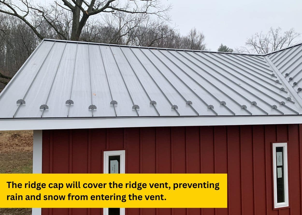 Finished standing seam metal roof with properly installed ridge cap.