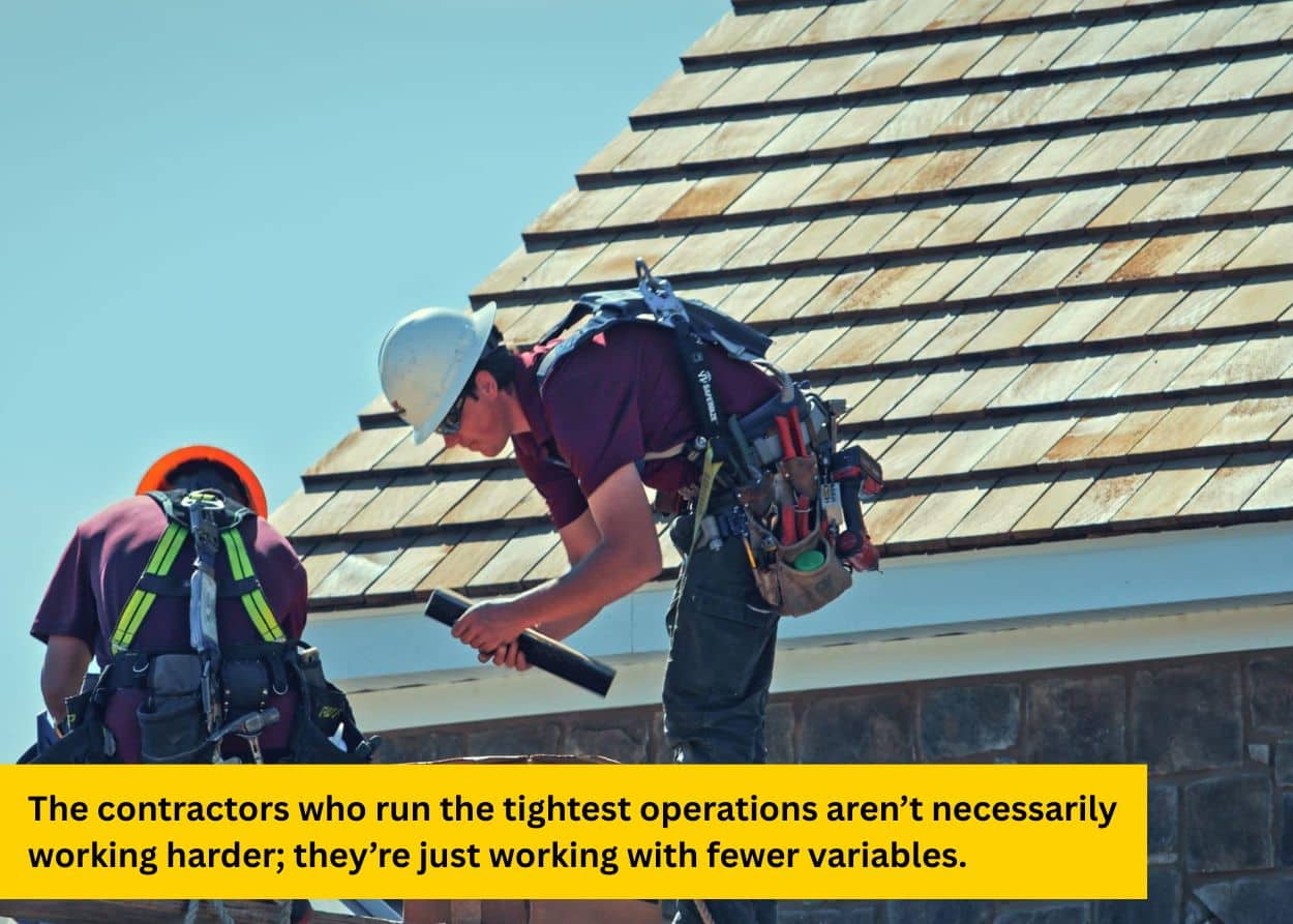 Roofers organizing materials and tools while working on standing seam roofing system